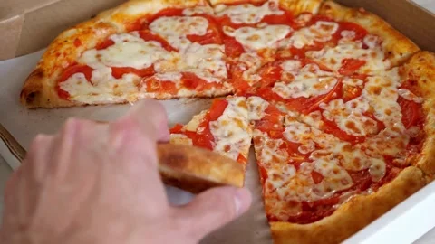 Top view of hands opening pizza cardboard box and taking slices of tasty pizza Vídeo Stock 336586710