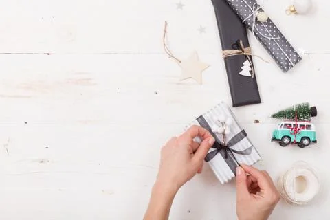 Top view on hands packing nice Christmas gifts. Presents, decor elements Stock Photos