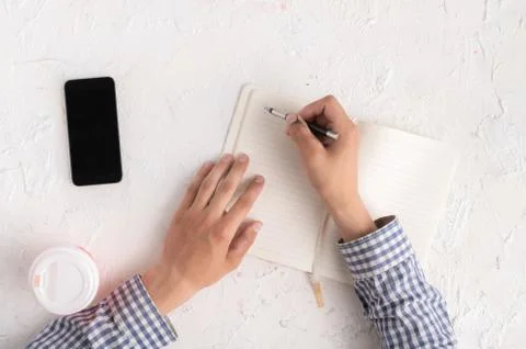 Top view of hands with pen taking notes at his workplace, copy spaces Foto stock