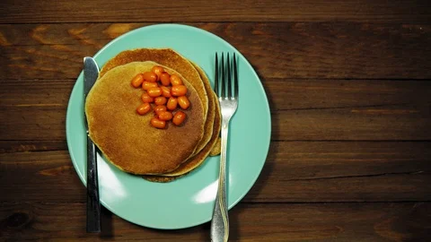 Top view hands put plate with pancakes and berries on wooden table, dolly shot. Vídeos de archivo 104660619