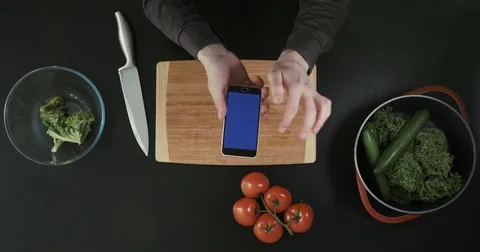 Top view of hands scrolling the phone screen. Hands holding the phone above the Stock Footage