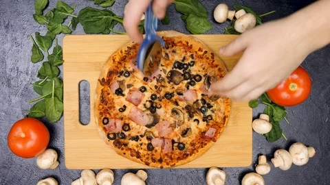 Top view of hands slicing a pizza Stock Footage 84788614