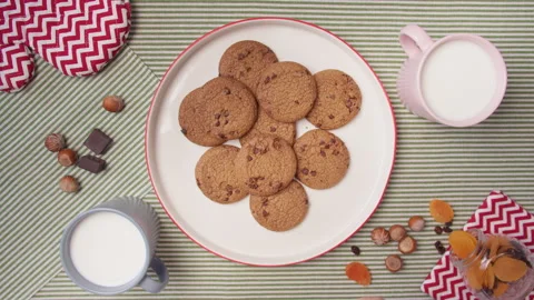 Top view hands take fresh cookies from plate and cup milk. Close up father's and Stock Footage 138098682