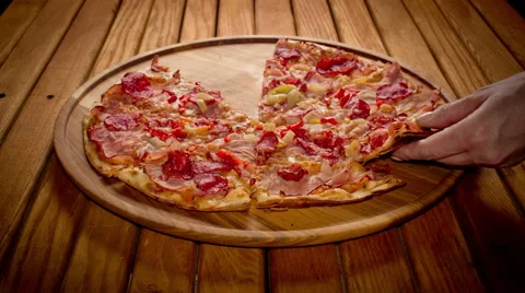 Top view hands taking big pizza cuts from wooden plate, stop motion animation Stock Footage 64530283
