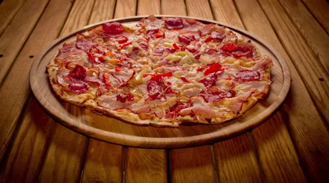 Top view hands taking big pizza cuts from wooden plate - stop motion Stock Footage 64530660