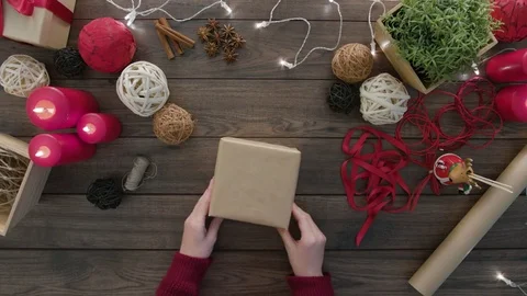 Top View Hands Tie a Bow Christmas Presents Stock Footage 81467334