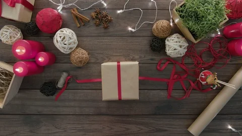 Top View Hands Tie a Bow Christmas Presents Stock Footage 81468492