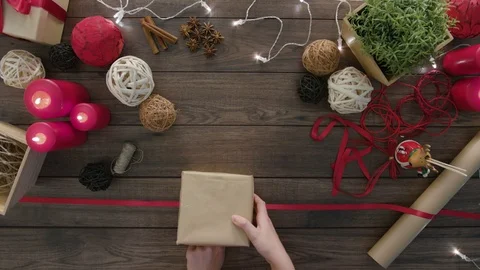 Top View Hands Tie a Bow Christmas Presents Stock Footage 81469496