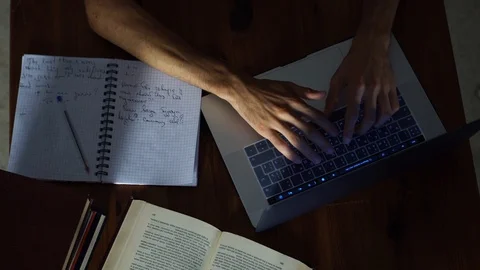 Top View, Hands Typing on Laptop Keyboard, Books, Notebooks on the Table Stock Footage 93275921