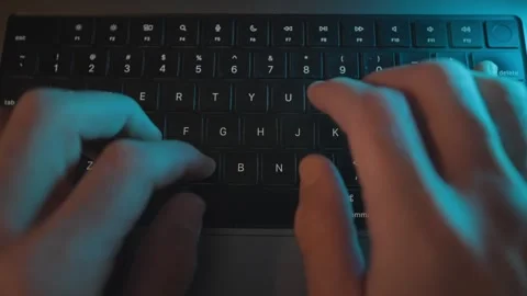 Top view on hands typing on laptop keyboard at night on office or home desk Stock Footage 340917831
