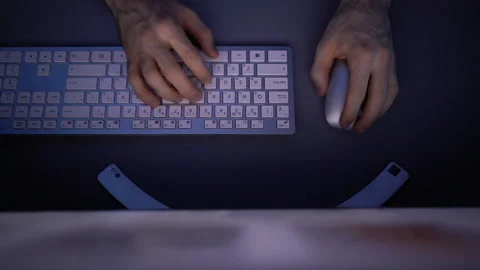 Top view of hands of unrecognizable man using wireless keyboard and computer Video stock 146316016