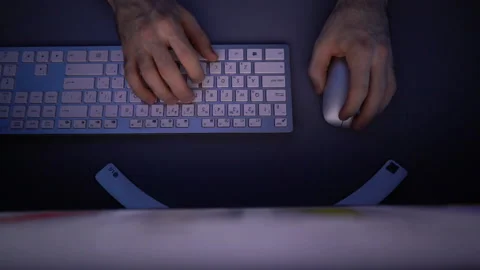 Top view of hands of unrecognizable man using wireless keyboard and computer Stock Footage 146353218