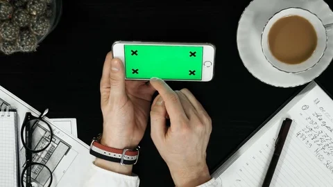 Top view hands using mobile phone touchscreen multi touch gestures green screen Stock Footage 74310444