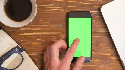 Top view hands using mobile phone touchscreen multi touch gestures green screen Video stock 88153996