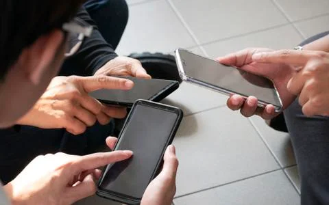 Top view hands using mobile - Multiracial friends , teamwork use gadget to co Stock Photos