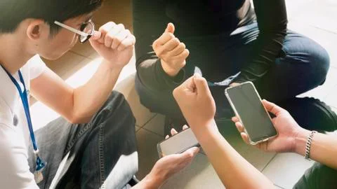 Top view hands using mobile - Multiracial friends , teamwork use gadget to ge Stock Photos