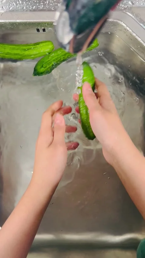 Top View of Hands Washing Fresh Green Cucumbers under Running Tap Water Stock Footage 338160929