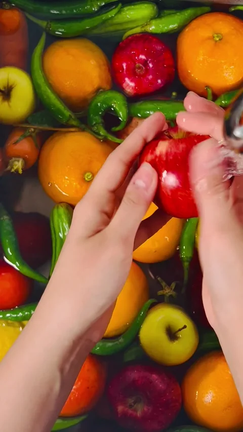 Top View of Hands Washing Mixed Fruits and Vegetables under Tap Water Stock Footage 338161472