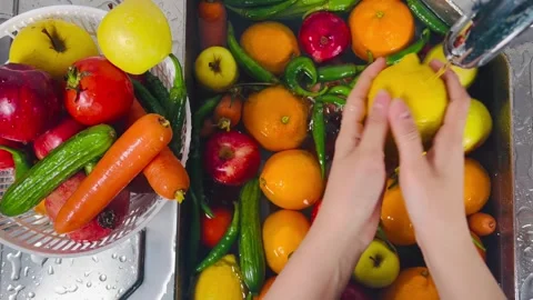 Top View of Hands Washing Mixed Fruits and Vegetables under Tap Water Stock Footage 338162708