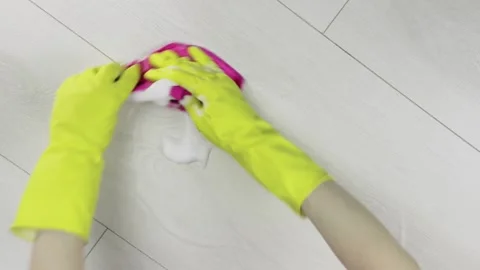 Top view of hands in yellow gloves wiping cleaning foam from the floor. Stock Footage 130720842