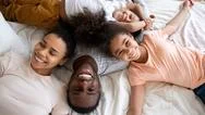 Top View Of Happy Biracial Family Relaxing On Bed Stock Photos
