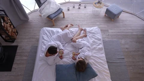 Top view happy couple clinking glasses drinking champagne white wine lying on Stock Footage 227504946