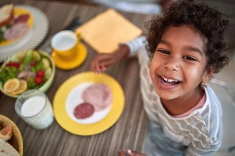 Top view of a happy smiling face of young afro-american girl at the kitchen t Stock Photos