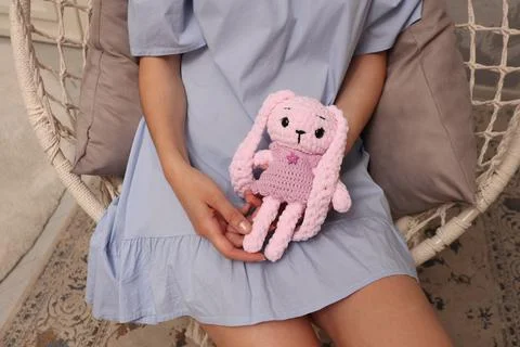 Top view of a hare in the hands of a young European woman. A young girl sits on Stock Photos