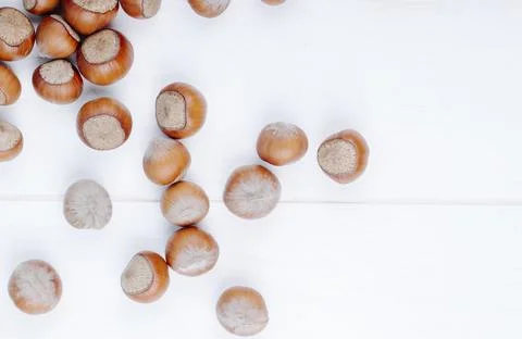 Top view of hazelnuts scattered on white background with copy space Stock Photos