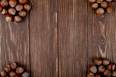 Top view of hazelnuts in shell on wooden background with copy space Fotos Stock