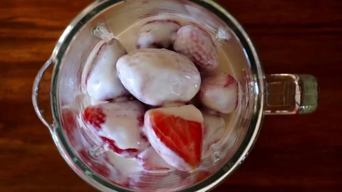 Top view hd video of blender shaking strawberry with milk Stock Footage 76016042