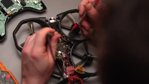Top view from head of skilled electronics technician soldering and repairing Stock Footage 302568096
