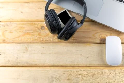 Top view headphone, laptop, Mouse and music player portable on wood table. Wi Stock Photos