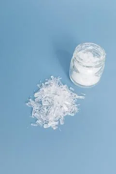 Top View Heap of Translucent Menthol Crystals on Blue Background, Glass Jar Stock Photos