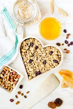 Top view of a heart shaped bow full of crunchy granola. Healthy eating concept Stock Photos
