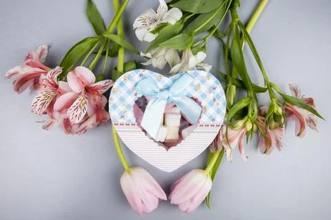 Top view of a heart shaped present box with marshmallow and pink and white .. Stock Photos