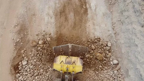 Top view of a heavy wheel loader pouring material over sieves Stock Footage 163375169
