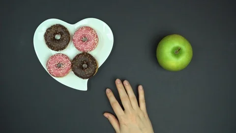 Top view of helping to get right choice between healthy and unhealthy food. Diet Stock Footage 95232469