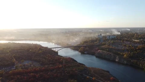 Top view of a high bridge over the river. Cinematic drone shot of the city with Stock Footage 171245168