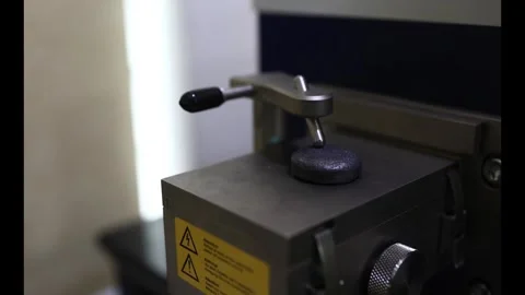Top view of high precision circular metal part held by quality control Stock Footage 336797386