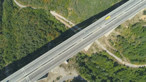 Top view of highway bridge with yellow and white truck driving along Stock Footage 115199968