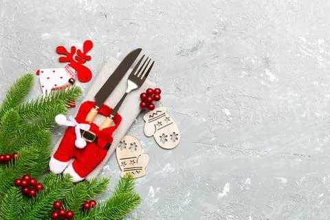 Top view of holiday objects on cement background. Utensils tied up with rib.. Stock Photos