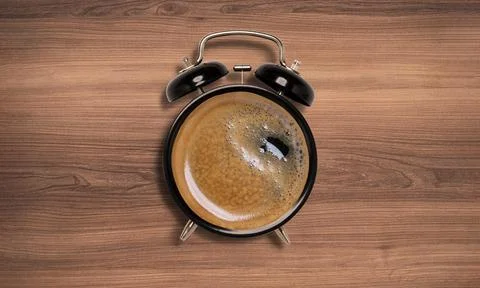 Top view of Hot Coffee inside face of alarm clock on  wooden background , wak Stock Photos