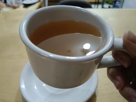Top view of hot tea with ginger and lemon in the cup Stock Photos