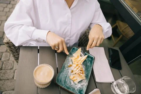 Top view of how a girl eats a cake and drinks coffee with glasses Stock Photos