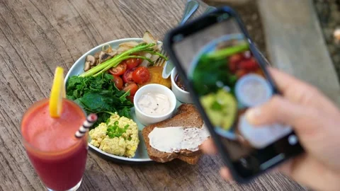 Top view of human hands taking pictures of a healthy plant based brunch with a Stock Footage 159801090