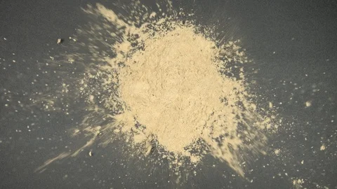 TOP VIEW: Human hands throw a ginger powder on a black table - Slow Motion Stock Footage 90240097