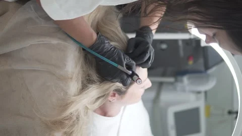 Top view of a HydraFacial Keravive scalp treatment performed by a cosmetologist Stock Footage 311873993