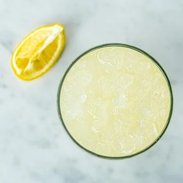 Top view of an ice cold yellow lemonade on a marble table surface Stock Photos