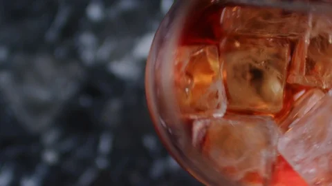 Top view of ice cubes mixing in a glass with drink. Bartender using a long metal Stock Footage 106467009